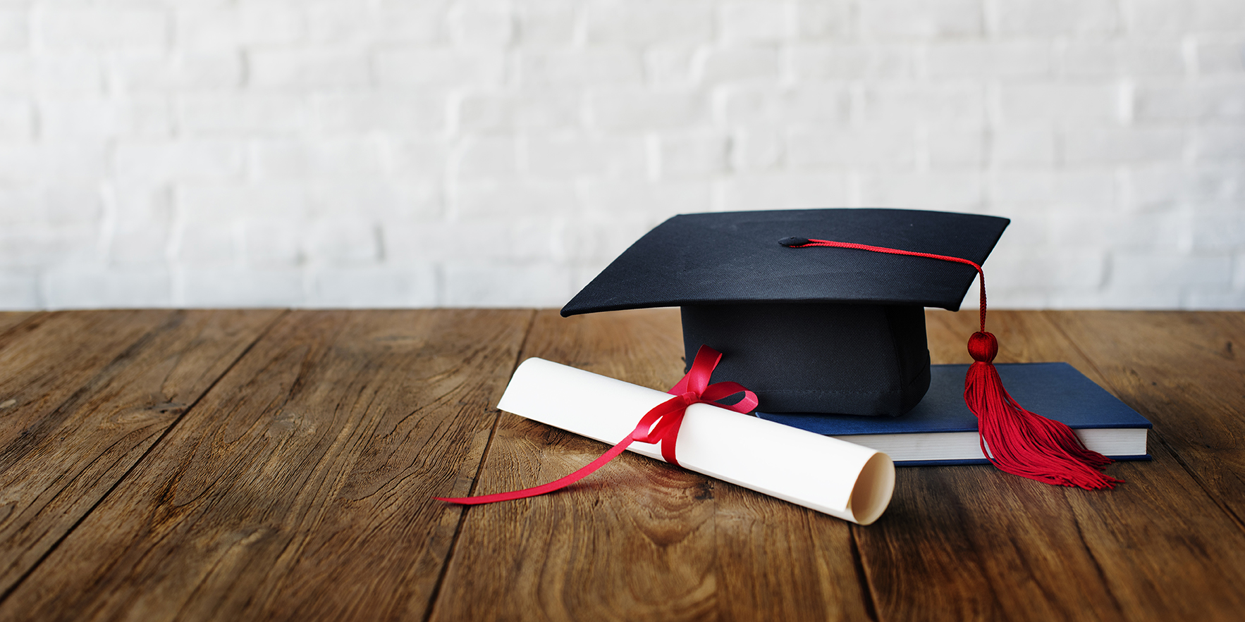 Mortar board and a graduation diploma